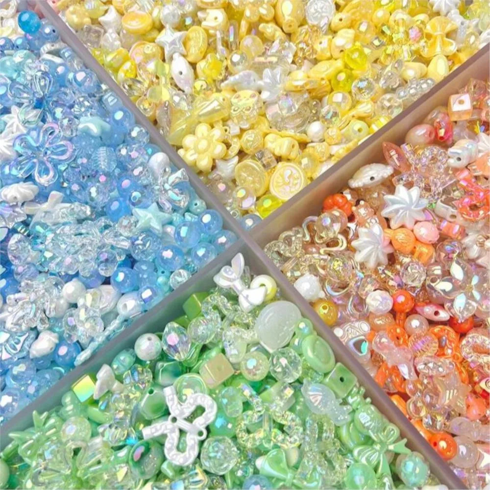 A close-up of various colorful acrylic bow and flower beads in shades of blue, yellow, pink, and green for DIY jewelry making