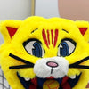 A bright yellow football mascot cat plush toy with black stripes and blue eyes.