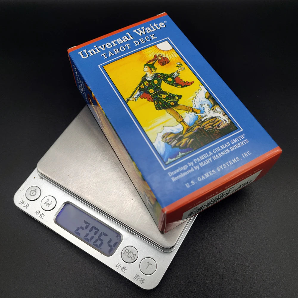 A box of Universal Waite Tarot Deck with a illustration of a tarot card on the front next to a calculator.
