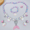 A set of five mermaid pearl jewelry pieces featuring pink, purple, and iridescent pearls and shell accents.
