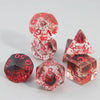 A set of translucent red and pink glitter polyhedral dice including a D4, D6, D8, D10, D12, and D20.