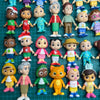 A collection of colorful cartoon PVC figurines featuring various characters and designs.