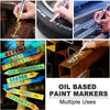 A collection of oil-based paint markers with various colors and tips being used to mark surfaces.
