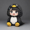 A cute plush toy resembling a penguin with black and white fur, yellow feet, and large eyes.