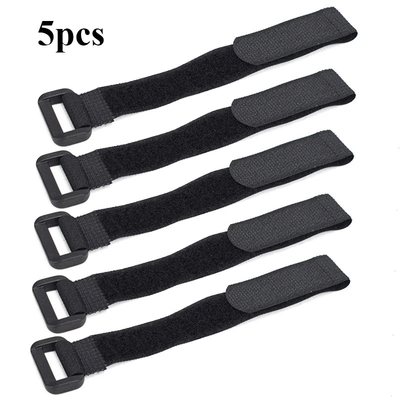A set of five black nylon bike handlebar straps for securing flashlights and gear.