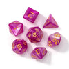 A set of seven purple acrylic polyhedral dice, including a d4, d6, d8, d10, d12, d20, and d100.