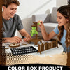 A young man and woman are playing a magnetic hangman board game with wooden pieces and a green peg figure.
