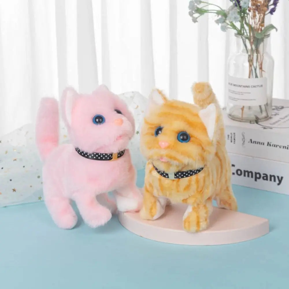 A pink and yellow plush cat toy with motion features displayed on a light blue surface.