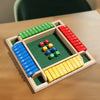 A wooden dice game board with colored dice and numbered slots for 2 to 4 players.