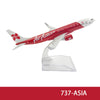 A diecast model of an AirAsia airplane in red and white livery.