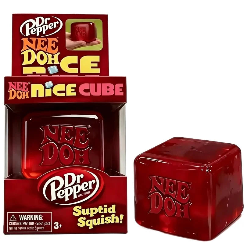 A box and a cube of Dr Pepper Nee Doh Squish fidget toy in red and gold packaging.