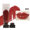 A tube of dark red lip glaze and a wand applicator for the Maxfine Hydrating Mirror Lip Glaze shade 05