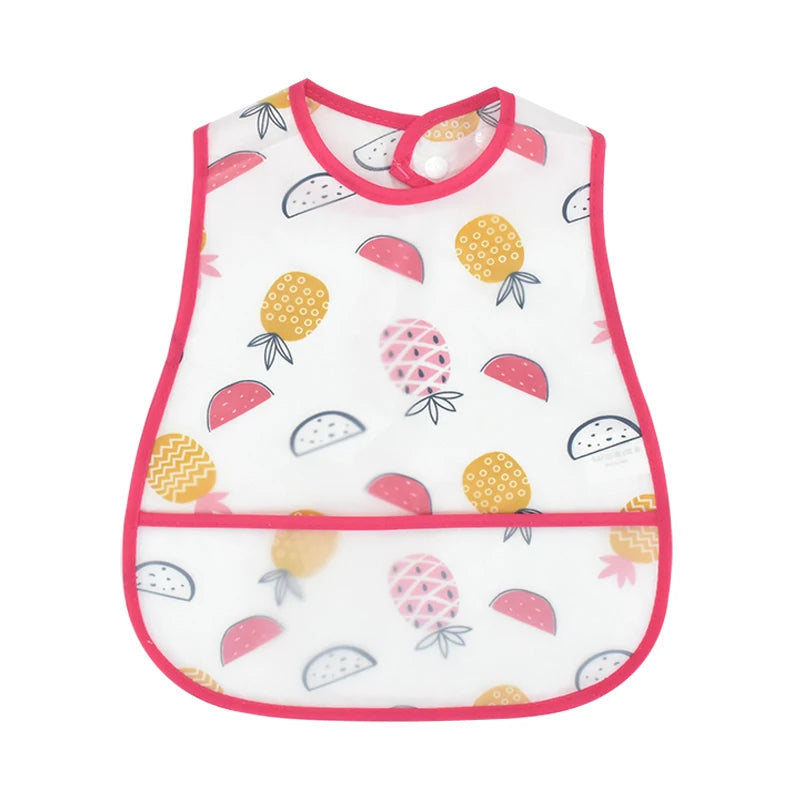 White baby bib with a cartoon pattern featuring strawberries and other fruit shapes