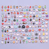 An assortment of gold-tone enamel charms for jewelry making, featuring various shapes and designs.