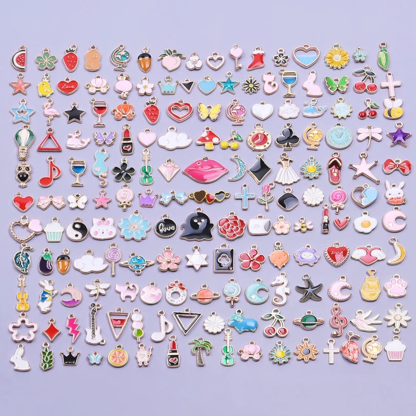 An assortment of gold-tone enamel charms for jewelry making, featuring various shapes and designs.