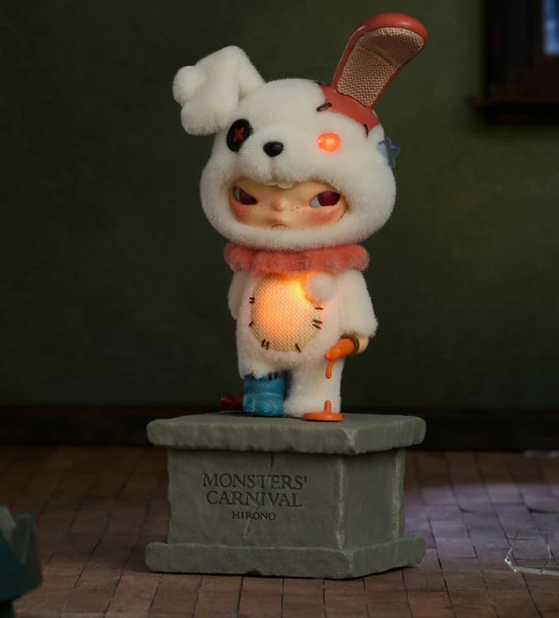 A white collectible figure resembling a monster with large eyes and a pink ear, standing on a stone base.