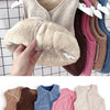 A collection of cozy lamb wool baby vests in various neutral and pastel colors displayed on a hanger.