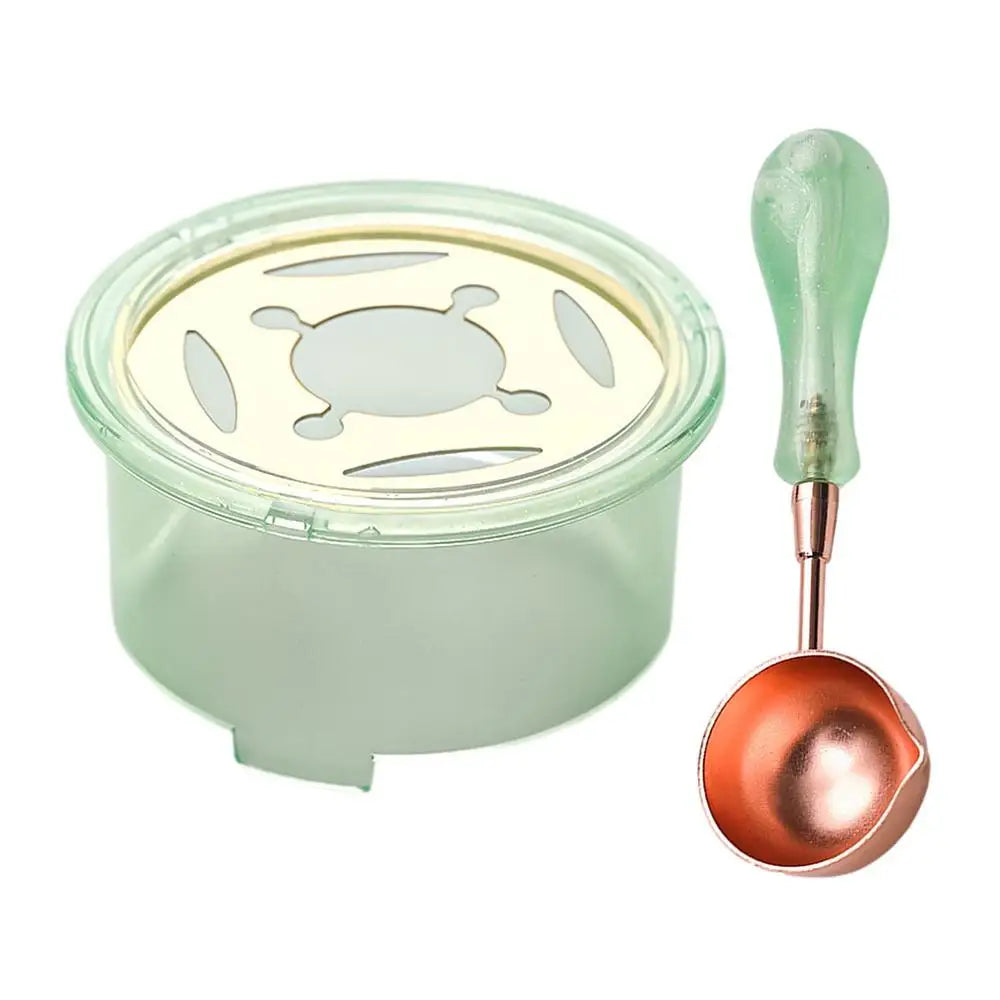 A clear container of wax is shown next to a green heater and a copper-colored spoon for an elegant wax seal melting kit.