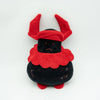 A plush toy resembling a rabbit with red floppy ears and a black body.