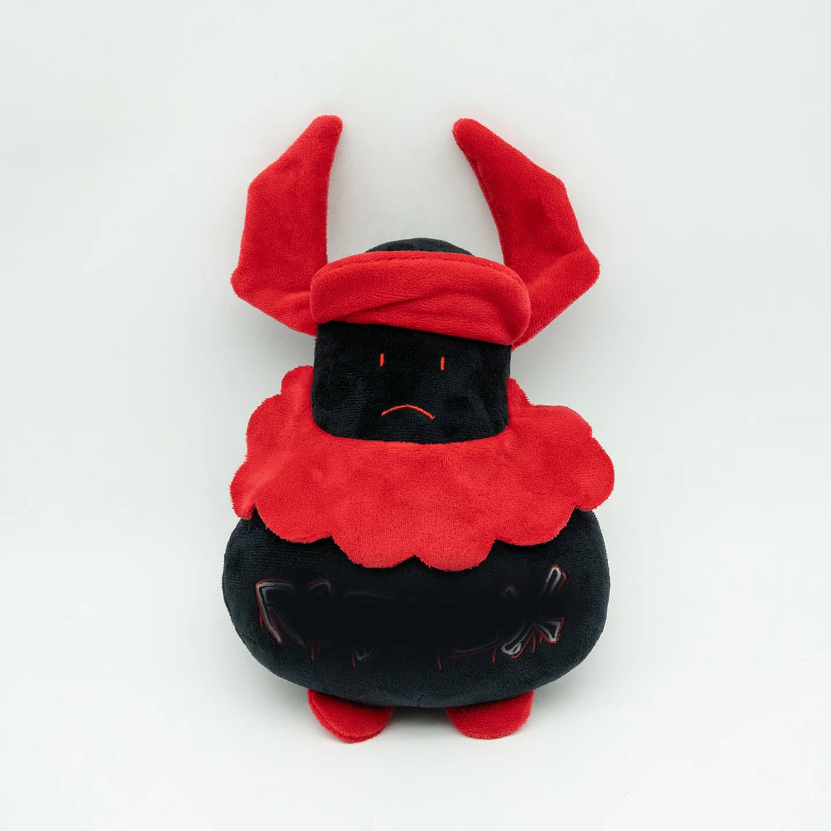 A plush toy resembling a rabbit with red floppy ears and a black body.