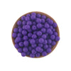 A wooden bowl filled with purple silicone round beads for jewelry making and DIY crafts