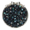 A collection of dark blue and green glitter cat eye resin beads in a silver-toned dish.