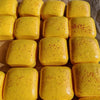 A collection of yellow sticky cubes used as a slow-rising squishy stress relief toy.