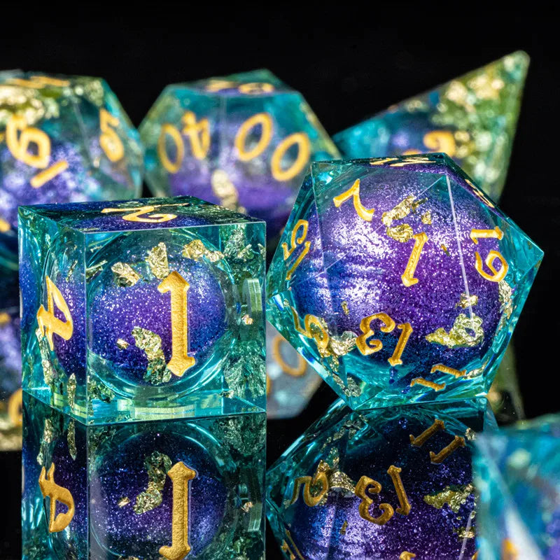A close-up of a set of iridescent, translucent blue and purple resin dice with gold accents.