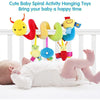A set of colorful spiral hanging toys for babies, including a yellow bee and other plush animals, displayed above a baby lyin