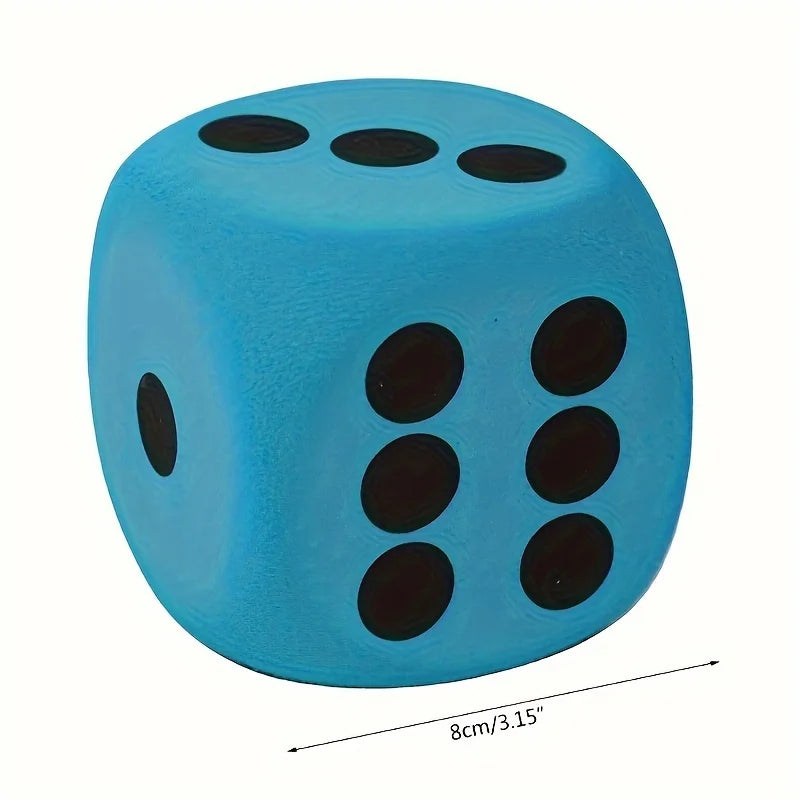 A bright blue jumbo soft foam die with black dots, shown from above.