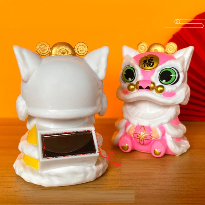 A white solar-powered shaking head lion figurine with pink accents and a solar panel on its chest.