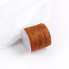 A roll of 0.8mm cotton nylon macrame cord in a copper or burnt orange color.