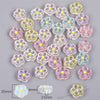 A collection of colorful enamel charm beads in various flower shapes and sizes for DIY jewelry making.