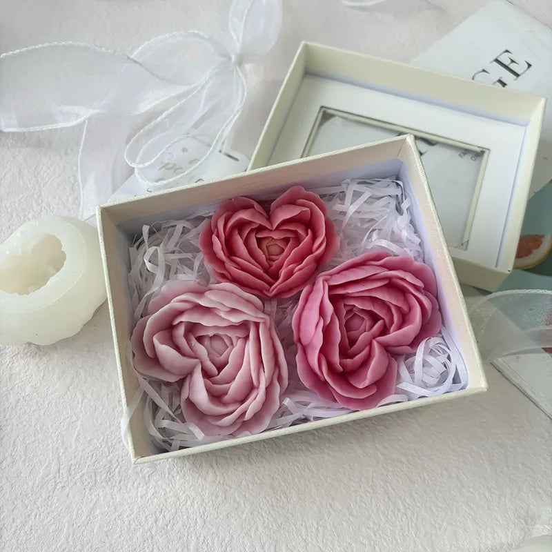 A white box contains pink heart-shaped flower silicone molds surrounded by shredded white material.