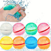 A hand is squeezing a blue water balloon, surrounded by various colorful reusable water balloons.