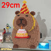 A large wooden building block shaped like a bear with a crown and a cake, used as a pen holder or desk organizer.
