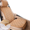 A tan quilted car seat protector with a plush, anti-slip backing shown in a vehicle seat.