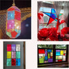 A collection of transparent colored PVC sheets in various hues displayed in a window frame.
