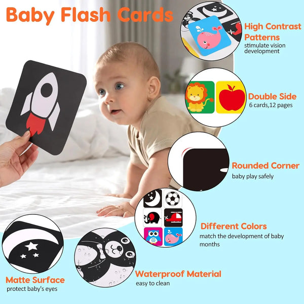 A baby holding a black flash card with a rocket design, demonstrating high contrast patterns for vision development.