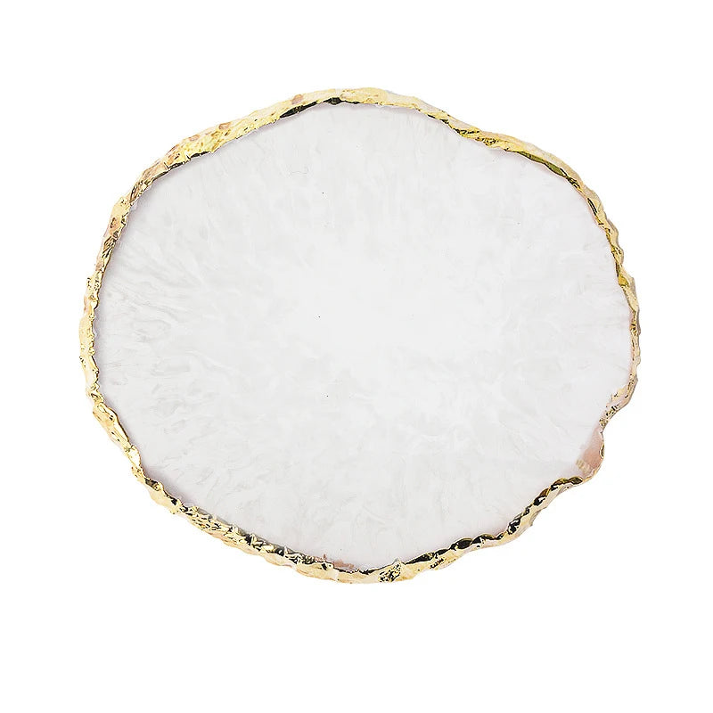A round white resin nail art palette with a gold trim edge.