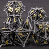 A pile of black metal dice, including a d10 and d20, is shown on a dark surface.