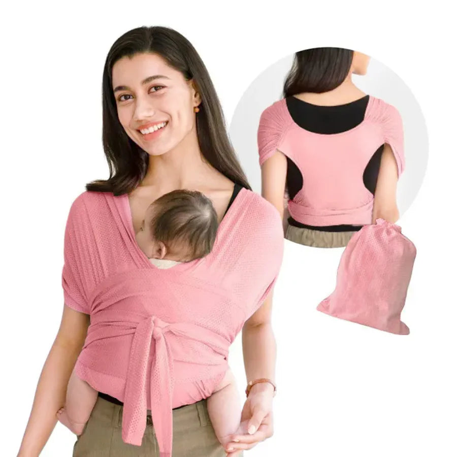 A woman wearing a pink X-shaped baby sling carrier with multifunctional back support.