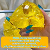 A hand holds a bright yellow honey cheese squishy toy, made from a smooth, jelly-like material.