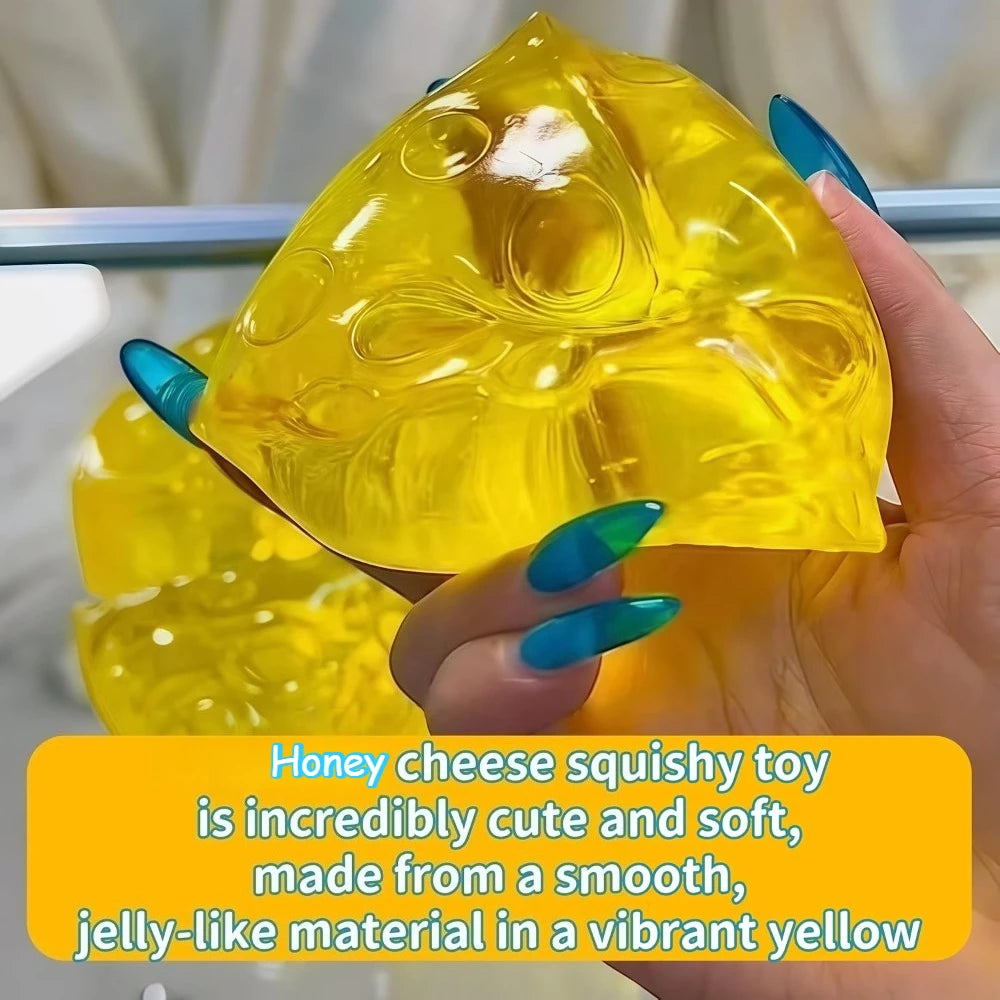 A hand holds a bright yellow honey cheese squishy toy, made from a smooth, jelly-like material.