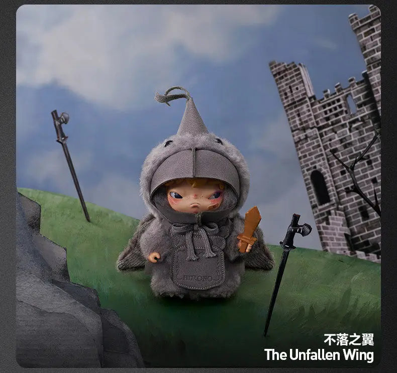 A gray plush doll wearing a conical hat stands in front of a stone castle backdrop.