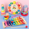 A wooden puzzle set featuring numbered discs, a toy elephant, and a wooden stick for early learning.