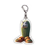 Acrylic keychain featuring a design of a green cactus and a pair of brown shoes.