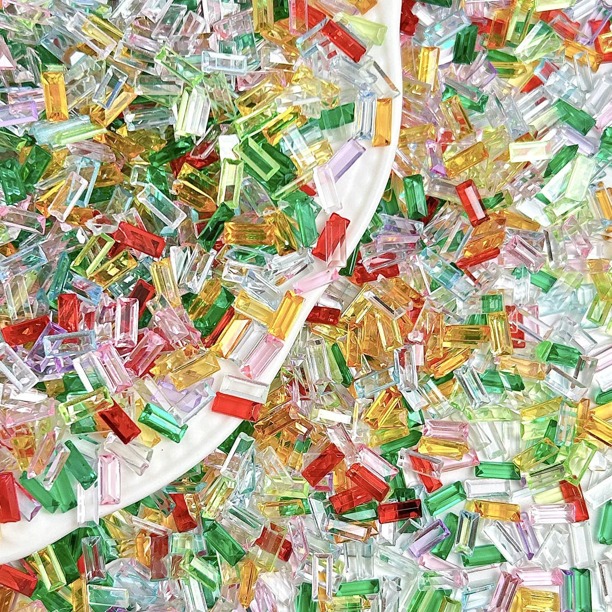 A pile of multicolor ice strip acrylic filler in various shades of green, yellow, pink, and red for nail art and crafts.