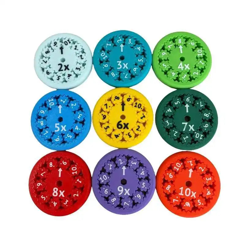 A collection of nine colorful math fidget spinners showing multiplication facts like 2x, 3x, 4x, 5x, 6x, 7x, 8x, 9x, and 10x