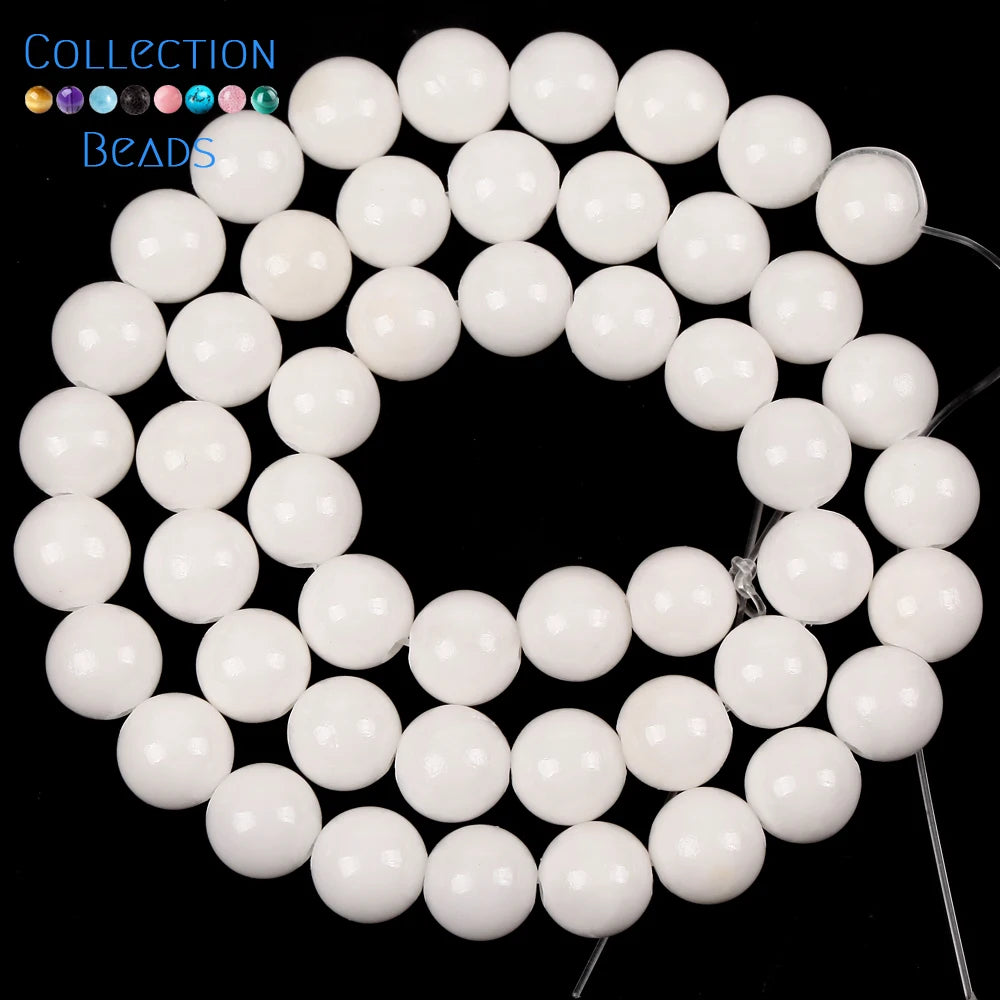 A collection of white and blue beads, including natural sea sediment jasper and turquoise, for jewelry making.